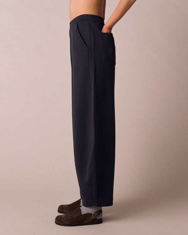 model wears helina washed black jersey trousers left