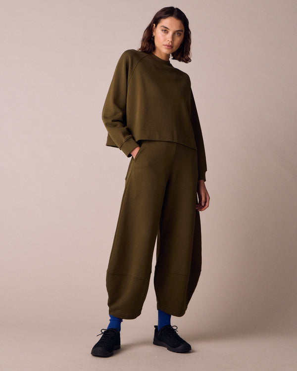 model wears earth green jersey jumper