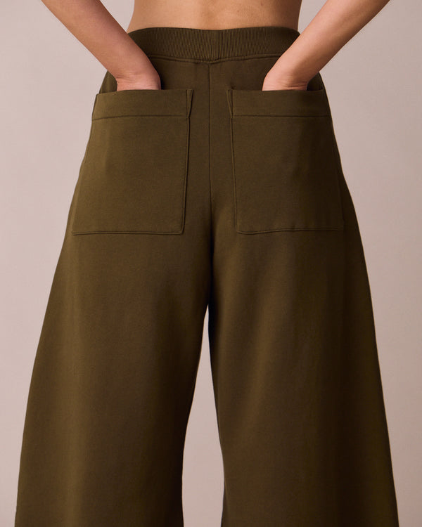 model wears pascale earth green jersey trousers