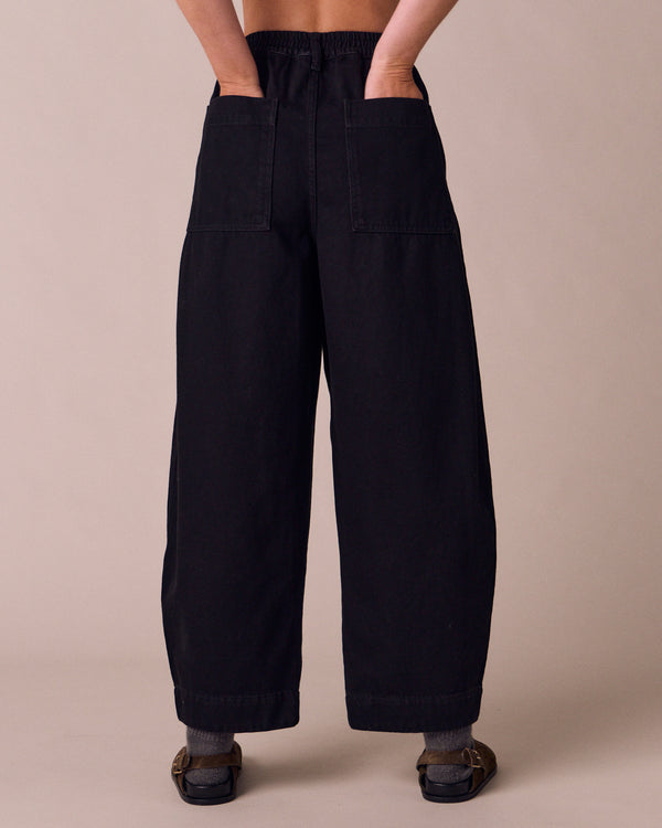 model wears veda true black denim jeans back