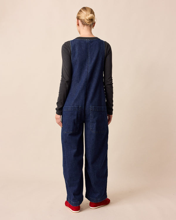 model wears ada dark blue denim jumpsuit