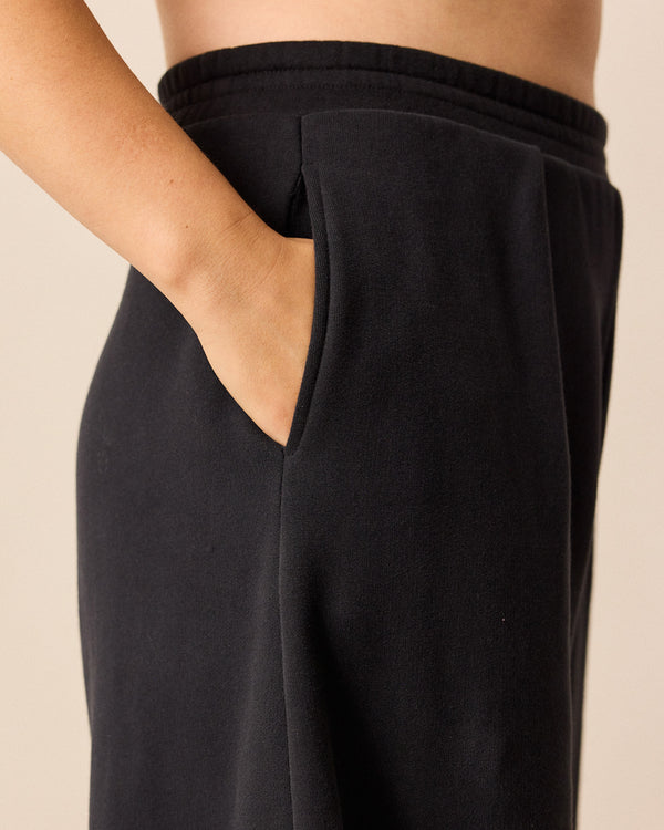 model wears daisy black jersey trousers