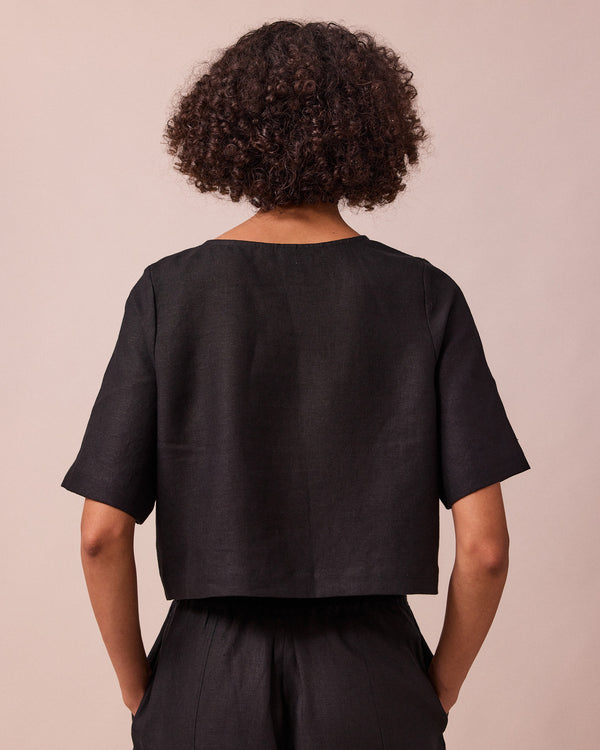 model wears evelyn black linen top