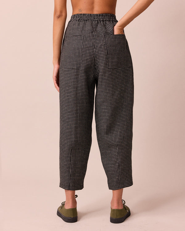 model wears huxley black mini grid linen trousers back