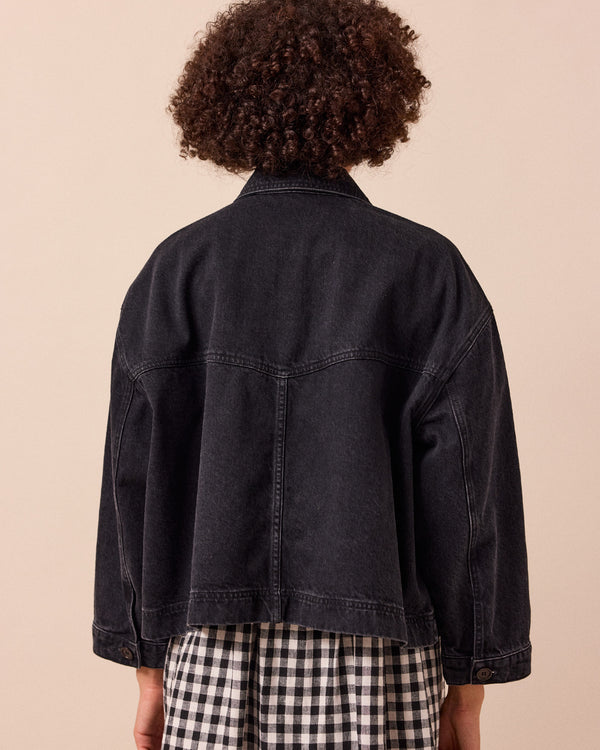 model wears kitty washed black denim jacket