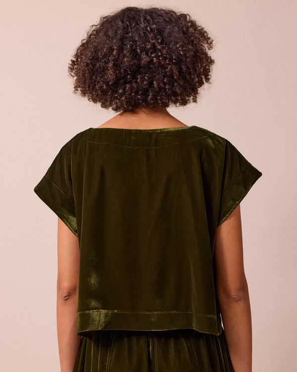 model wears polly moss green velvet top