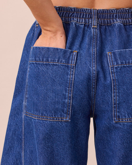 model wears tori mid blue wash denim jeans