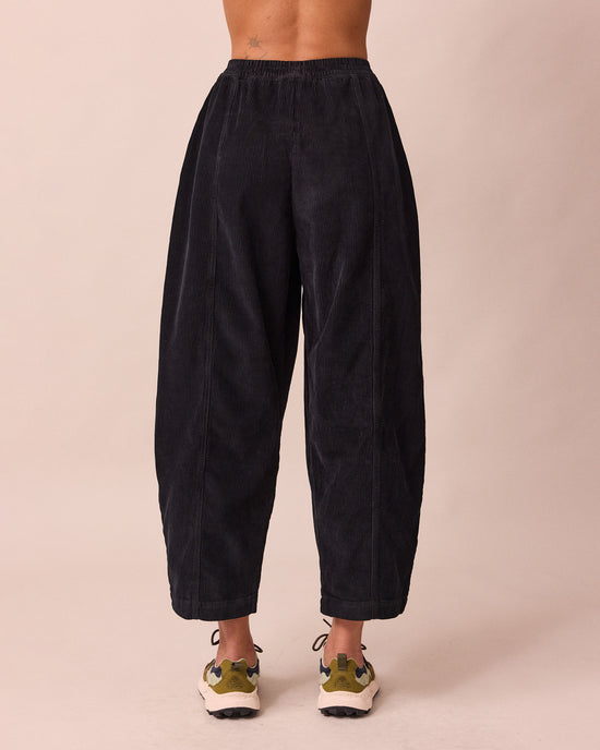 model wears mabel black cord trousers back