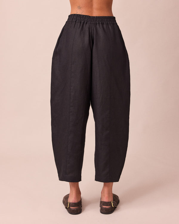 model wears mabel black linen trousers back