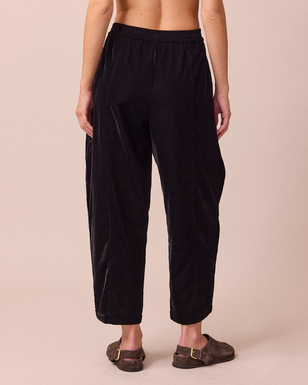 model wears mabel black velvet trousers back