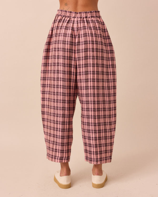 model wears mabel dewberry check linen trousers back