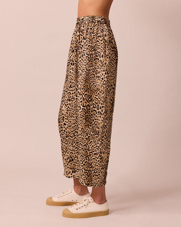 model wears mabel leopard print cupro trousers left