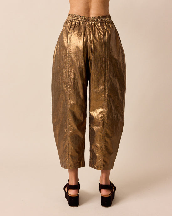 model wears mabel bronze linen trousers back