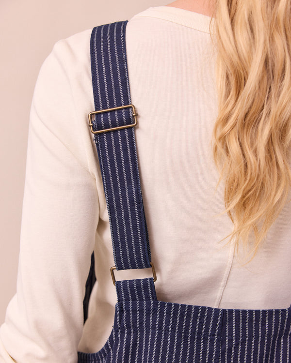 model wears ottie navy pinstripe denim jumpsuit