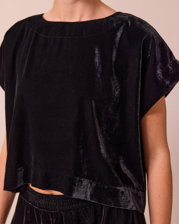 model wears polly black velvet top