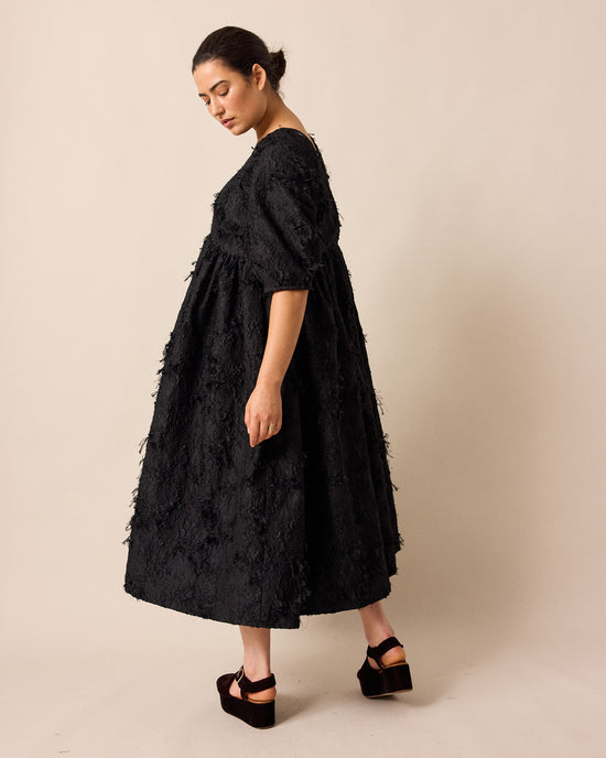 model wears prue black tufted dress