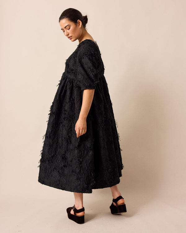 model wears prue black tufted dress