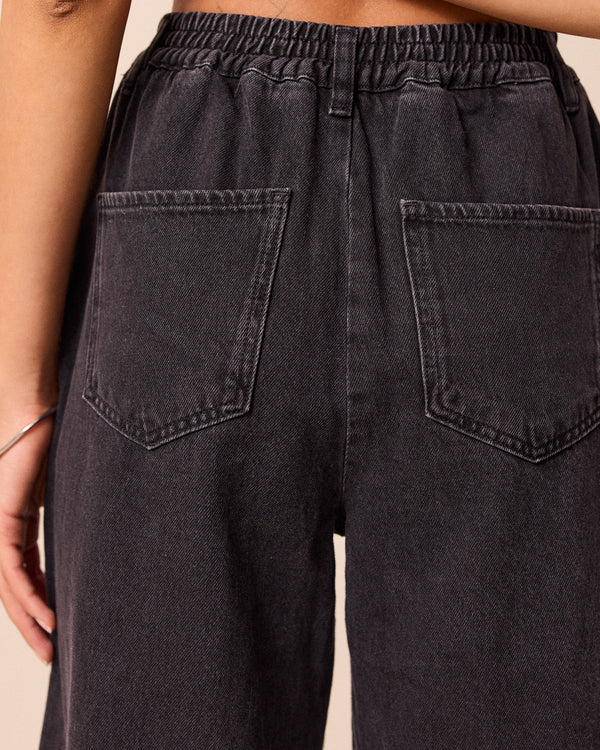 model wears remi washed black jeans front