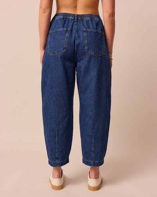 model wears remi mid wash denim jeans back