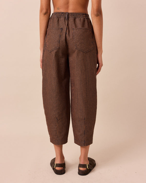 model wears remi hickory rust stripe jeans right