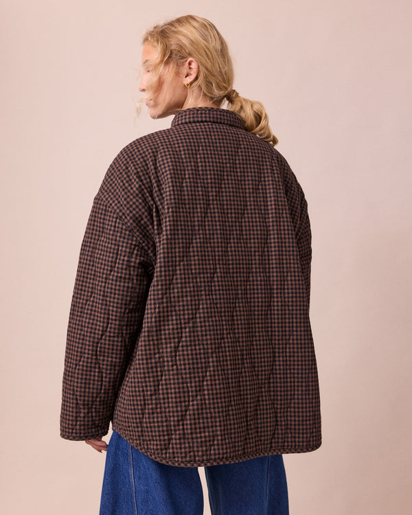 model wears rue cocoa gingham denim jacket