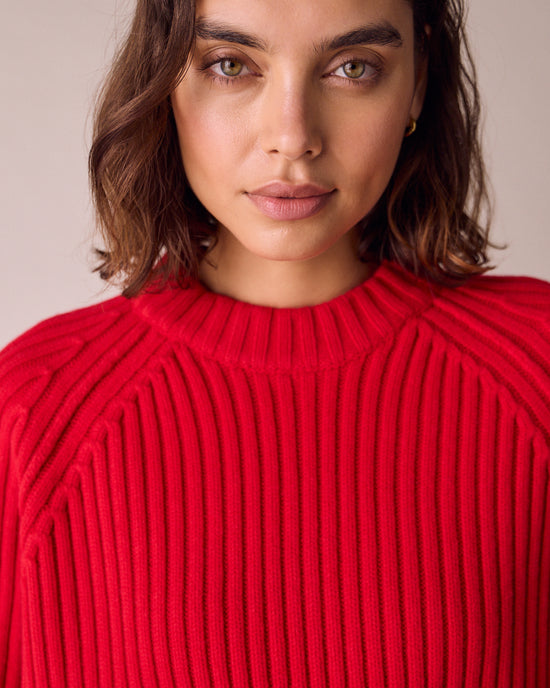 model wears cadi cherry red knitted jumper