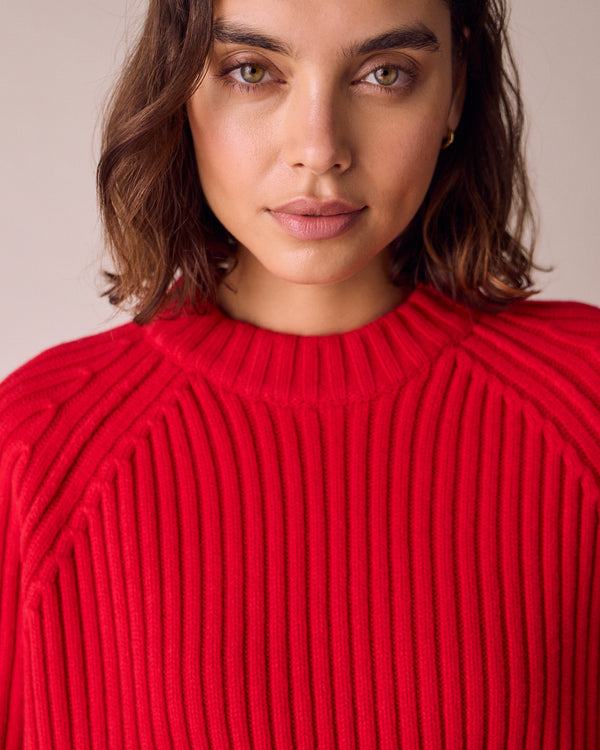 model wears cadi cherry red knitted jumper