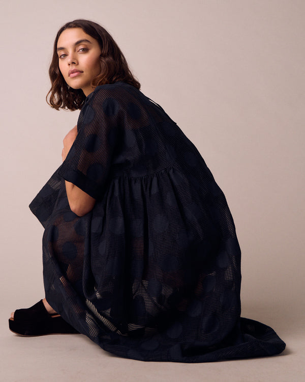 model wears zyla black sheer spot dress