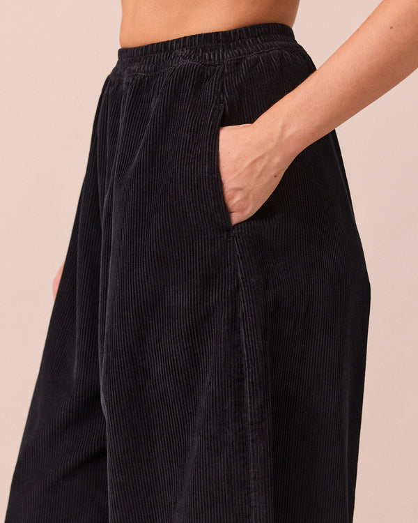 model wears daisy black cord trousers