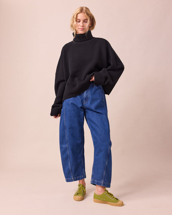 model wears tori mid blue wash denim jeans