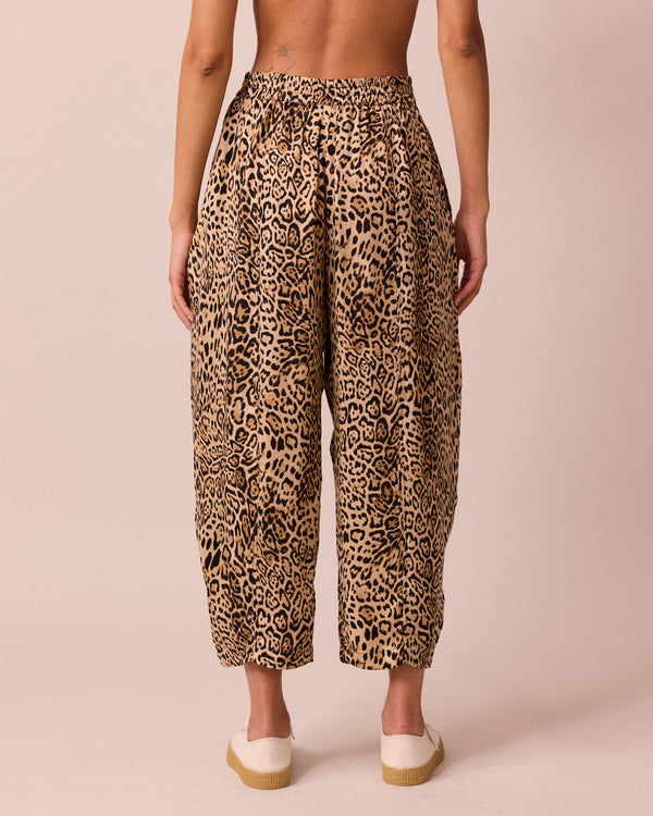 model wears mabel leopard print cupro trousers back
