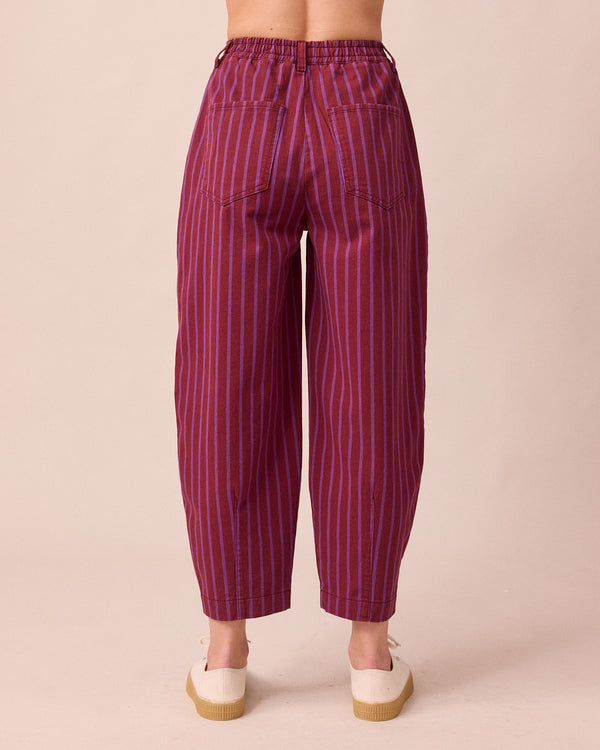 model wears remi russet and violet denim jeans back