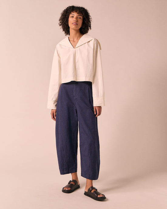 model wears dana midnight pinstripe cotton linen trousers left