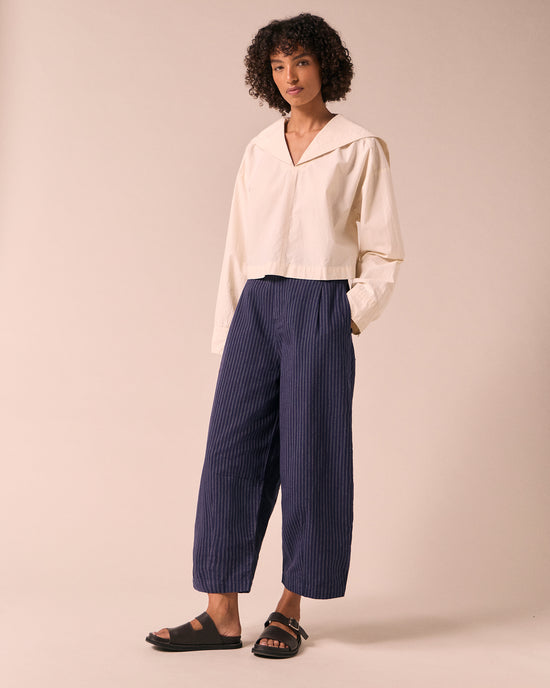model wears dana midnight pinstripe cotton linen trousers right