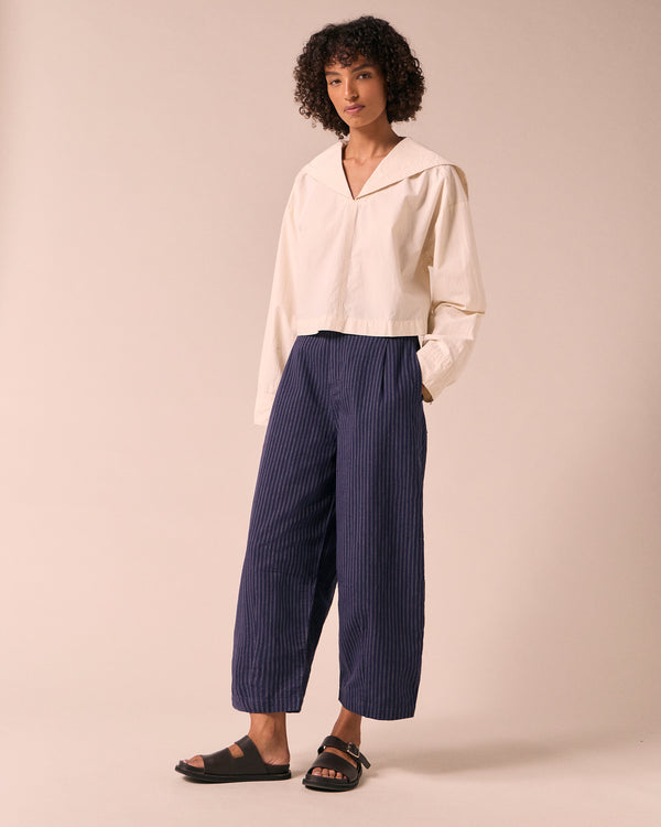 model wears dana midnight pinstripe cotton linen trousers right