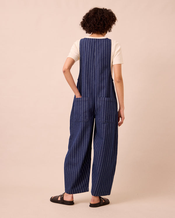 model wears ada mid blue pinstripe denim jumpsuit