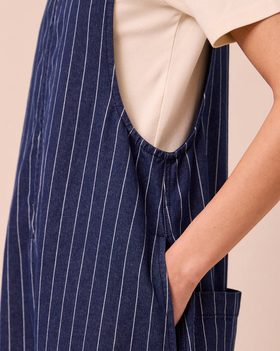 model wears ada mid blue pinstripe denim jumpsuit