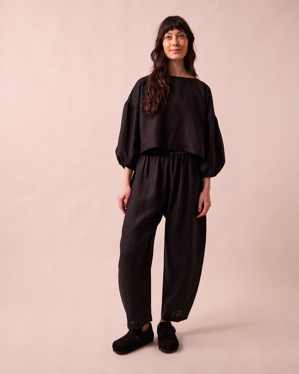 model wears aisha black linen top