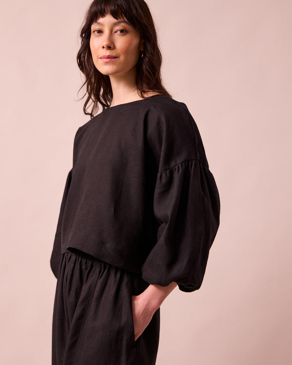 model wears aisha black linen top