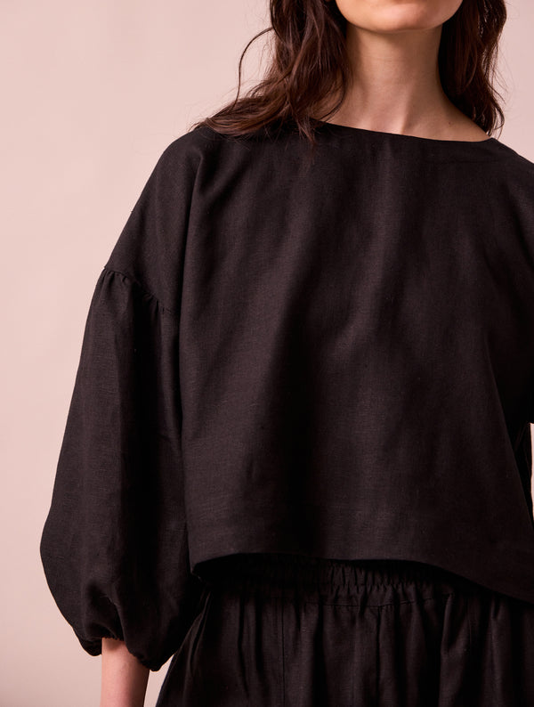 model wears aisha black linen top