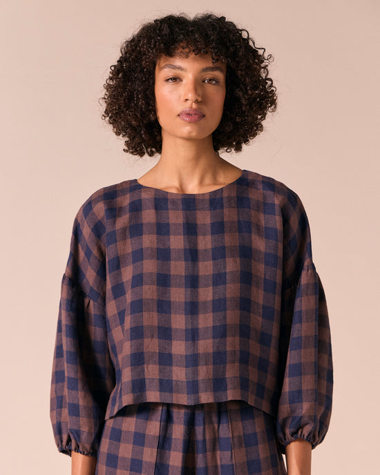 model wears aisha cedar check linen top