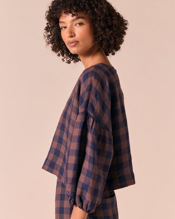 model wears aisha cedar check linen top