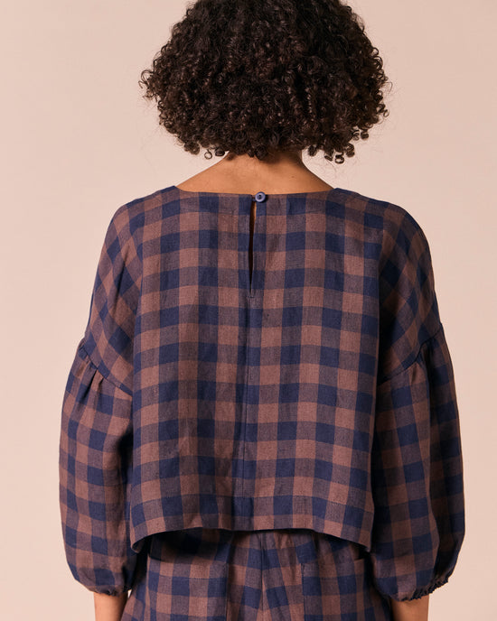 model wears aisha cedar check linen top