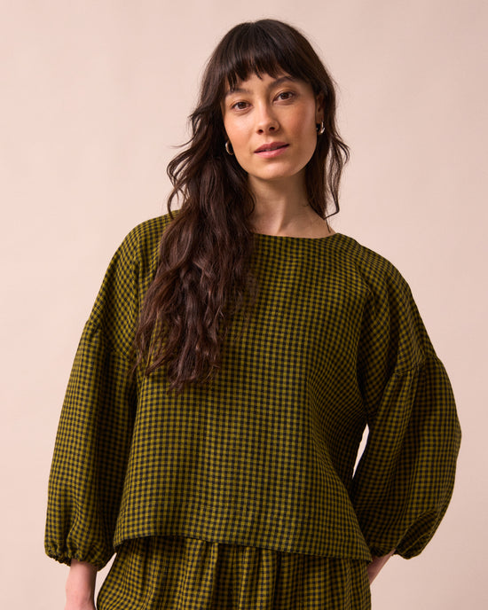 model wears the aisha fresh olive mini gingham linen top