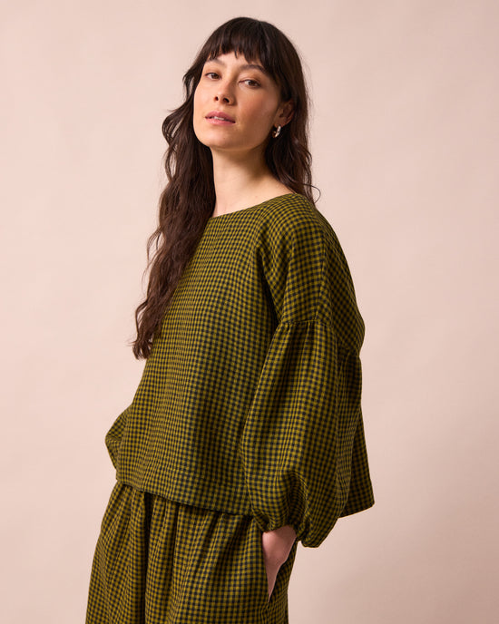 model wears the aisha fresh olive mini gingham linen top