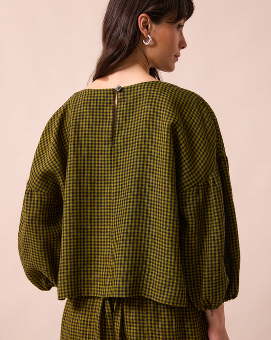 model wears the aisha fresh olive mini gingham linen top