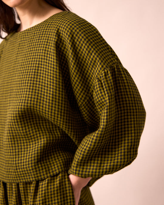 model wears the aisha fresh olive mini gingham linen top