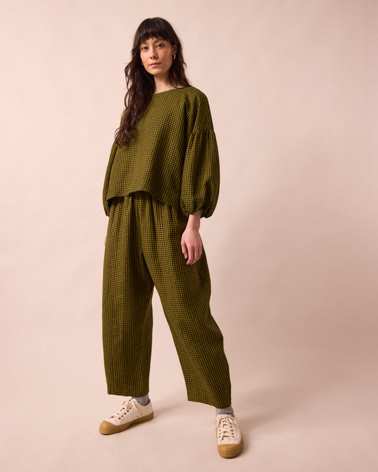 model wears the aisha fresh olive mini gingham linen top