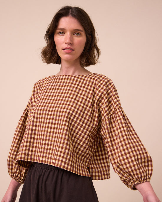 model wears aisha tan gingham seersucker top
