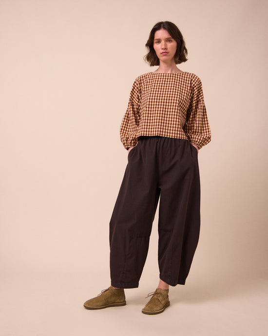 model wears aisha tan gingham seersucker top